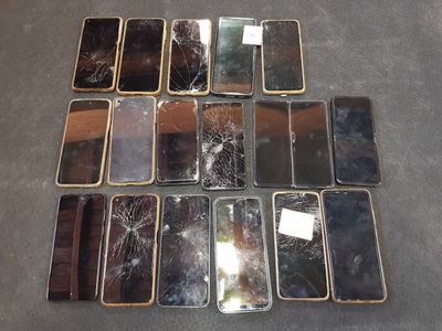 a lot of broken cell phones on the floor