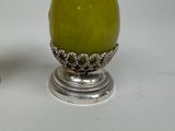 two green eggs sitting next to each other on a table