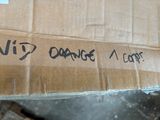a cardboard box with writing on it sitting on a table