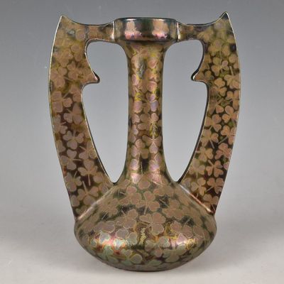 a vase that is sitting on a table with flowers on it