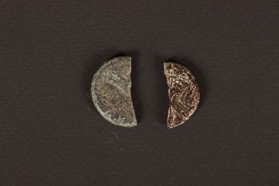 a close up of two pieces of metal on a black surface