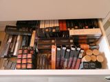 a drawer full of makeup and cosmetics items