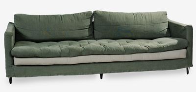 an image of a green couch with pillows on it