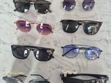 several pairs of sunglasses sitting on a table with a price tag