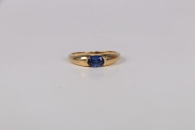 a close up of a gold ring with a blue sapphire stone