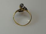 a close up of a gold ring with a black diamond on it