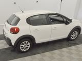 a picture of a small white car parked in a garage