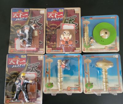 six action figures of various characters in plastic boxes on a table