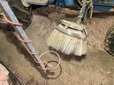 a broom that is laying on the ground next to a truck