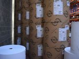 several rolls of paper are stacked on top of each other in a warehouse