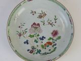 a plate with flowers on it on a white surface