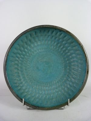 a blue plate that has a circular design on it