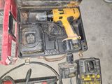 a tool box with a hammer, drill, and other tools in it