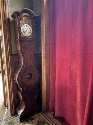 a grandfather clock sitting in the corner of a room