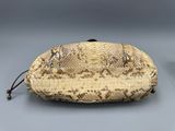 an image of a snake skin purse on a gray surface