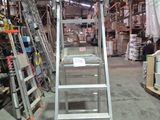 a ladder that is sitting in the middle of a warehouse