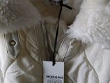 a white jacket with a fur collar on a hanger