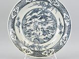 a blue and white plate with a landscape scene on it