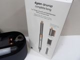 a box with a pen and other items on a table
