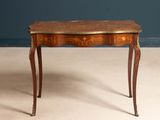 a small table with a wooden top on a white floor