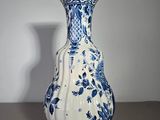 a blue and white vase sitting on a table