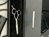 a black box with a pair of scissors inside of it