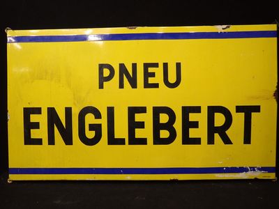 panneau jaune et noir portant l'inscription « pneu englebertt »
