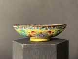 a colorful bowl sitting on top of a wooden pedestal
