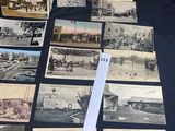 several old black and white photographs of people and vehicles on a table