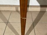 a wooden table with a drawer underneath it on a tiled floor