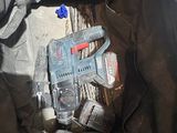a person holding a corded drill in a bag
