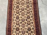 rug on the floor in a room with a chair and a table
