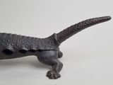 a small statue of a lizard that is on a table