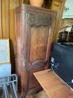 a large wooden cabinet with a tv on top of it