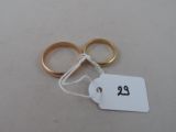 a pair of gold wedding rings with a price tag