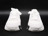 the white sneakers are on a black surface with a black background