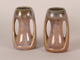 two brown vases sitting next to each other on a table