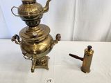 a small brass teapot and a small brass teapot on a table