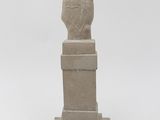 statue of a hand with a finger up on a pedestal