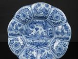a blue and white plate with a floral design on it