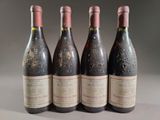 three bottles of red wine are lined up on a table