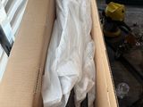 a cardboard box with a pair of scissors inside of it