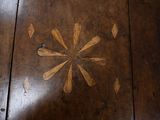 a wooden floor with a flower design on it