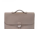 a grey leather briefcase with a metal clasp on the handle