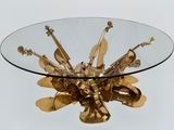 a glass table with a gold metal object on top of it