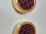 two pairs of gold plated stud earrings with red and black spots