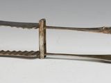 a knife and a fork on a white surface