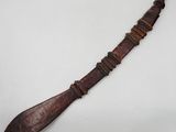 an old wooden knife with a long blade on a white surface