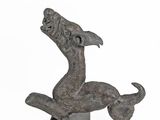 statue of a mermaid on a rock on a white background