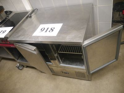 a stainless steel counter with a door open and a sign on it